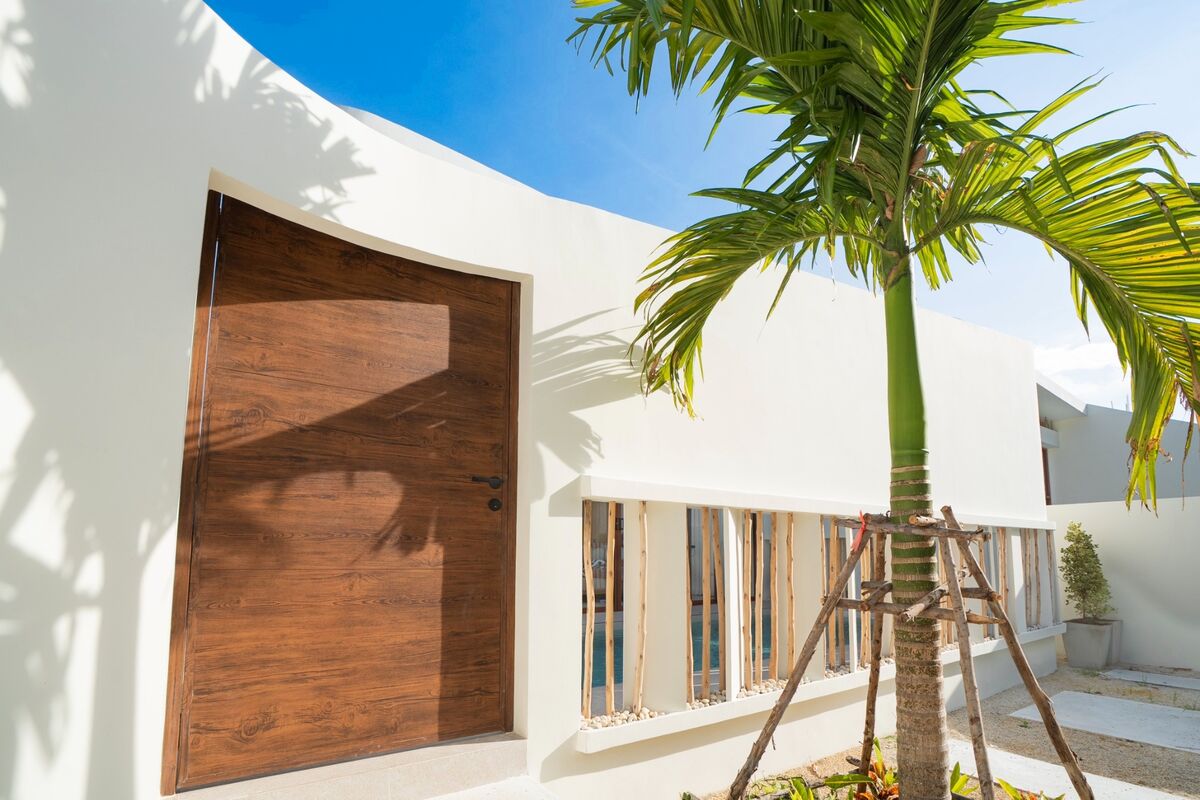 Villa exterior framed by palms